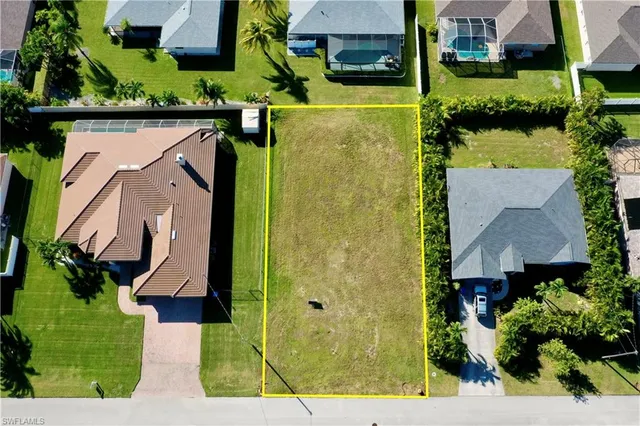 an aerial view of a house with a yard basket ball court and outdoor seating