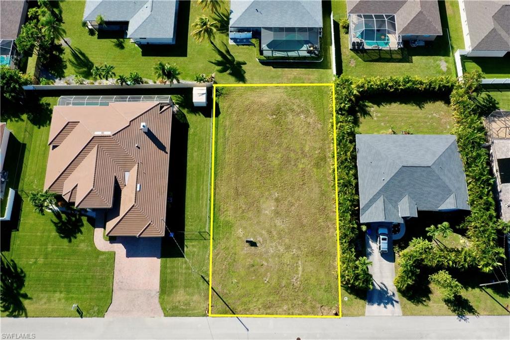 an aerial view of a house with a yard basket ball court and outdoor seating