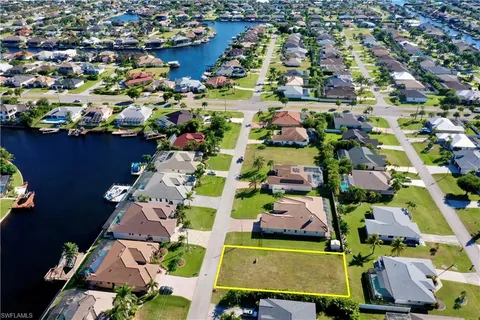 an aerial view of residential houses with outdoor space and swimming pool
