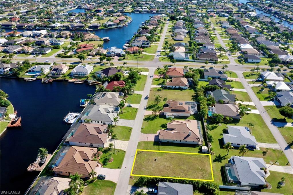 4710 Southwest 23rd Avenue Cape Coral, FL 33914 - Photo 2 of 5 an aerial view of residential houses with outdoor space and swimming pool