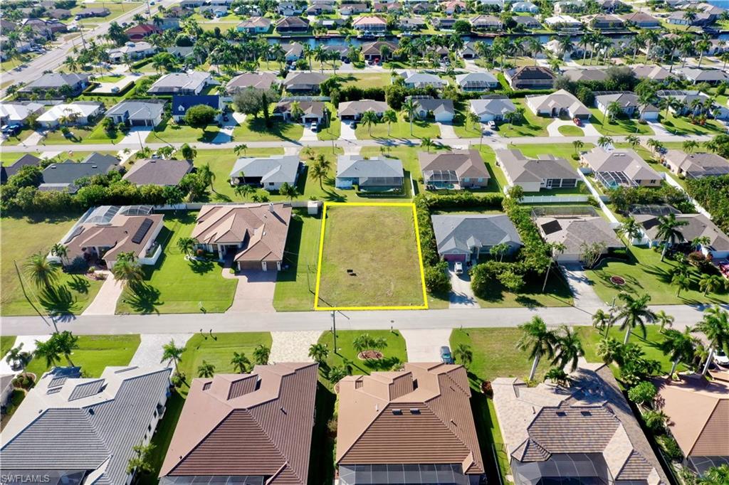4710 Southwest 23rd Avenue Cape Coral, FL 33914 - Photo 4 of 5 an aerial view of residential houses with outdoor space