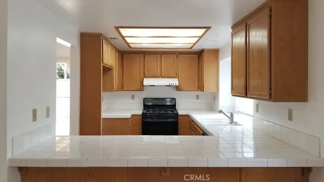 a kitchen with a refrigerator and a stove