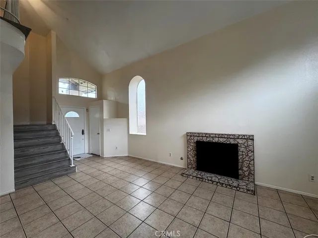 a view of a livingroom with a fireplace and window