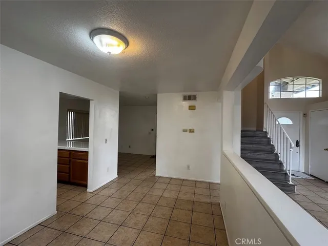 a view of a hallway with entryway and dining room