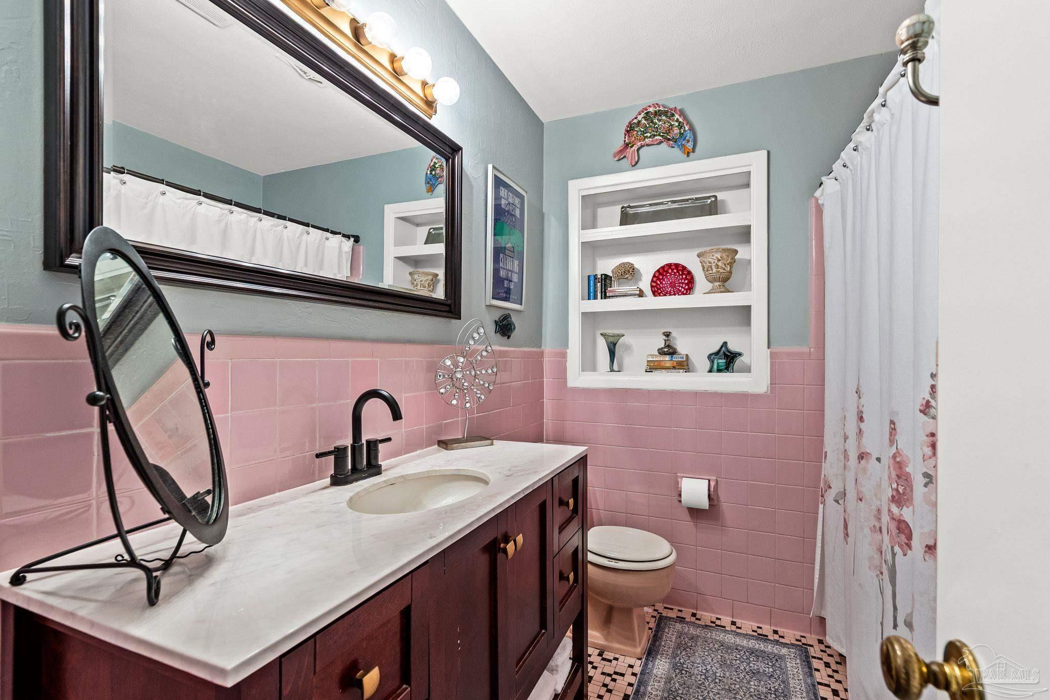 6001 Hilltop Road Pensacola, FL 32504 - Photo 21 of 37 a bathroom with a sink a vanity and a mirror