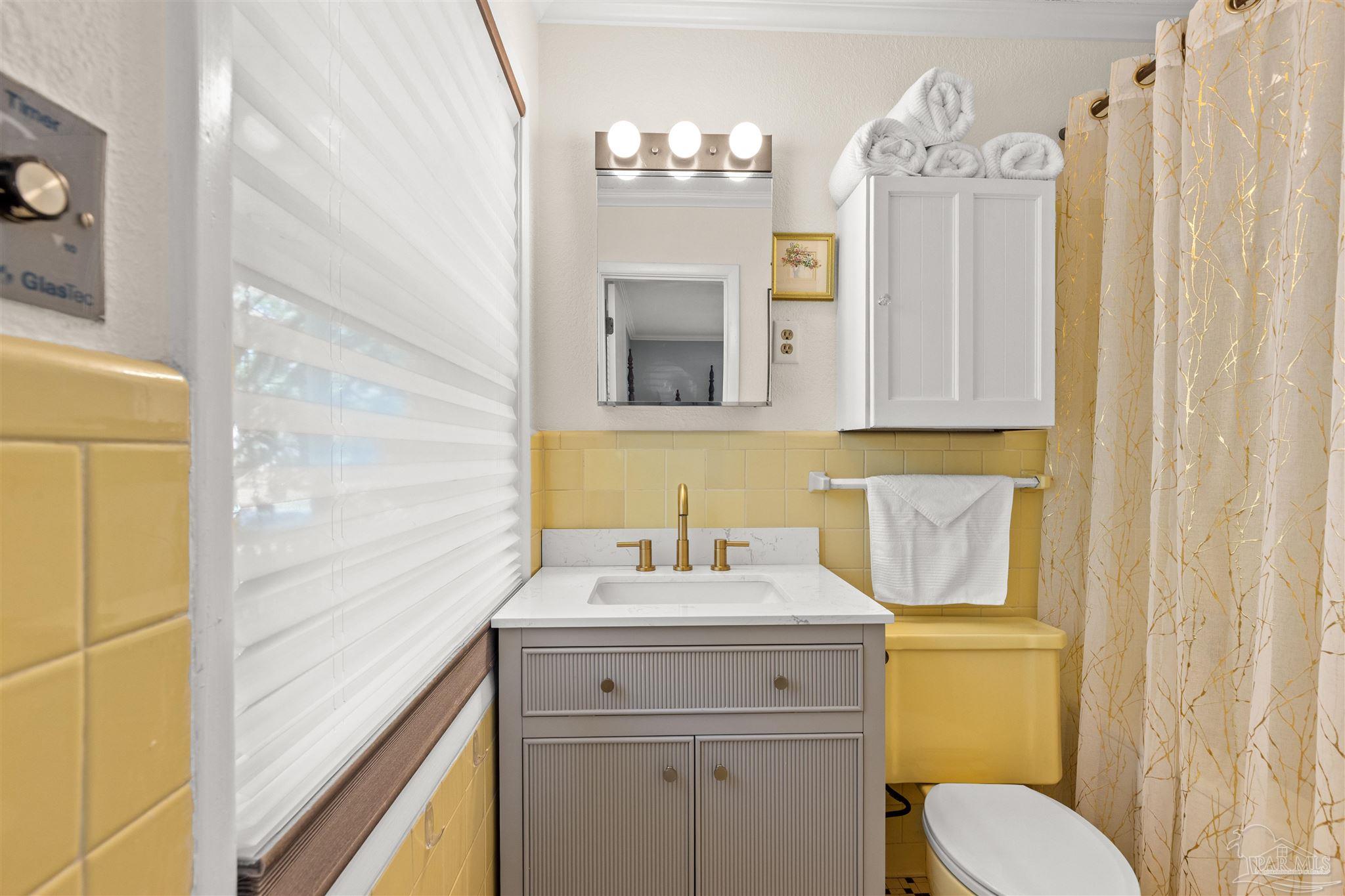 6001 Hilltop Road Pensacola, FL 32504 - Photo 26 of 37 a bathroom with a sink vanity mirror and toilet