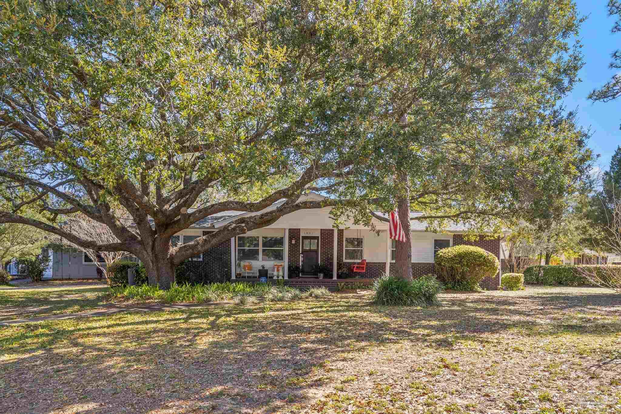 6001 Hilltop Road Pensacola, FL 32504 - Photo 3 of 37 a front view of a house with garden