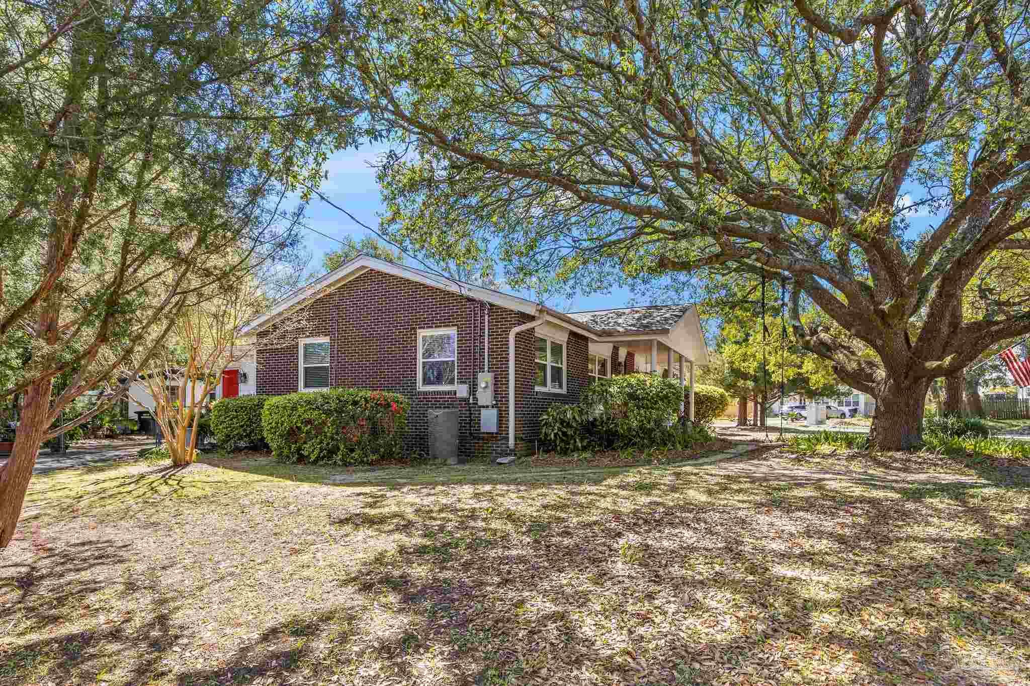6001 Hilltop Road Pensacola, FL 32504 - Photo 33 of 37 a front view of a house with a yard and garage