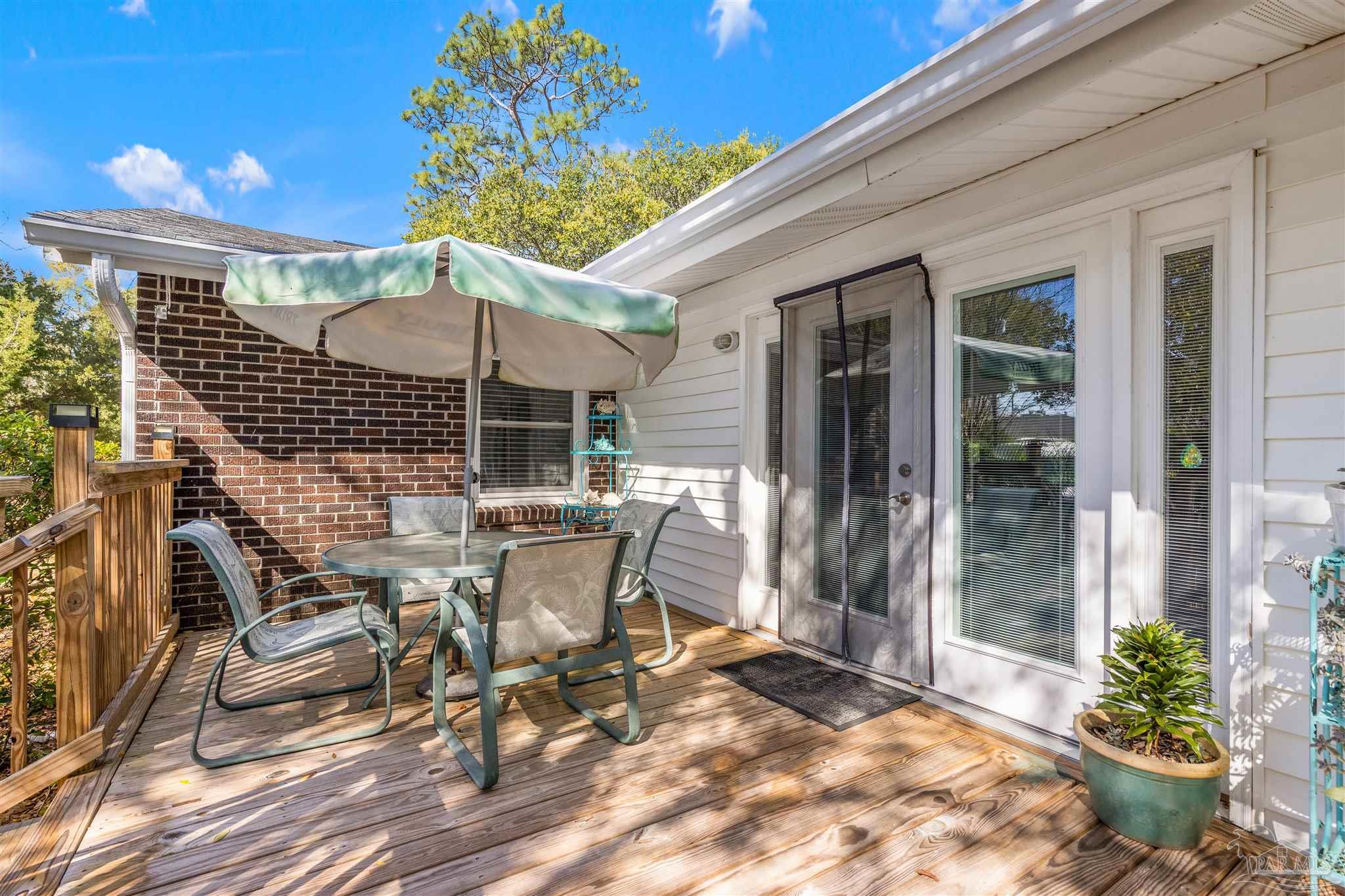 6001 Hilltop Road Pensacola, FL 32504 - Photo 37 of 37 a view of a patio with table and chairs and potted plants