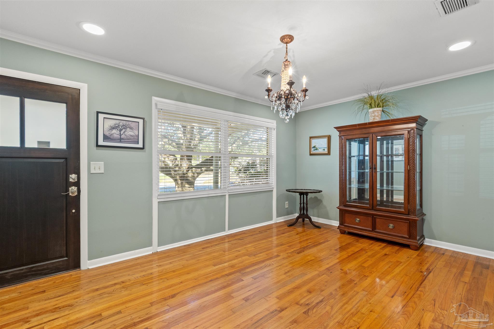 6001 Hilltop Road Pensacola, FL 32504 - Photo 5 of 37 a view of an empty room with a window and wooden floor