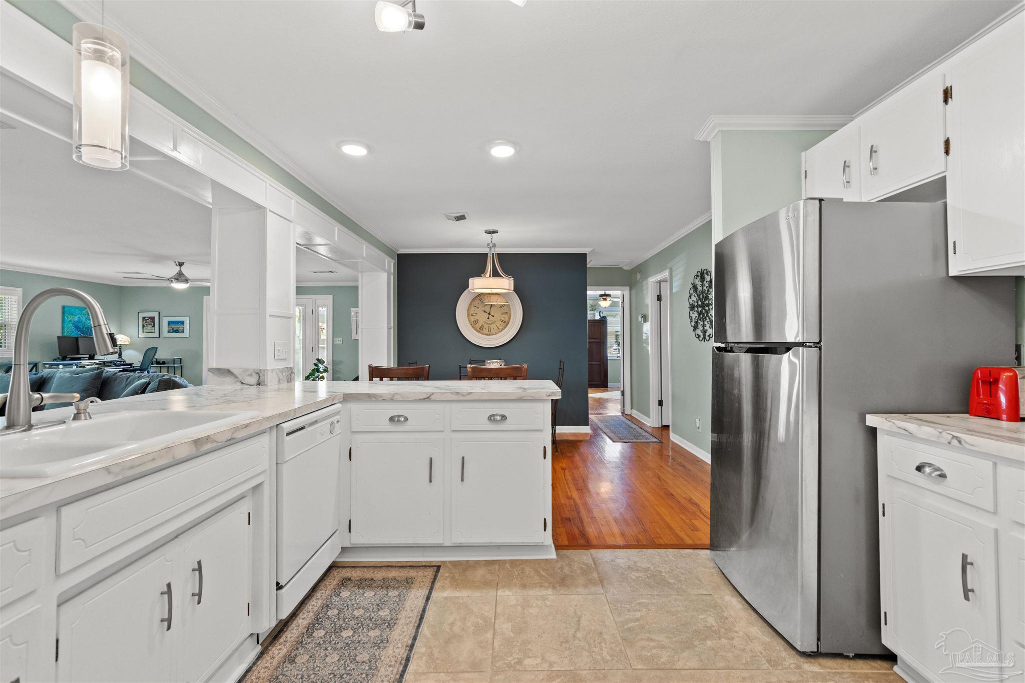 6001 Hilltop Road Pensacola, FL 32504 - Photo 8 of 37 a kitchen with stainless steel appliances granite countertop a refrigerator sink and cabinets