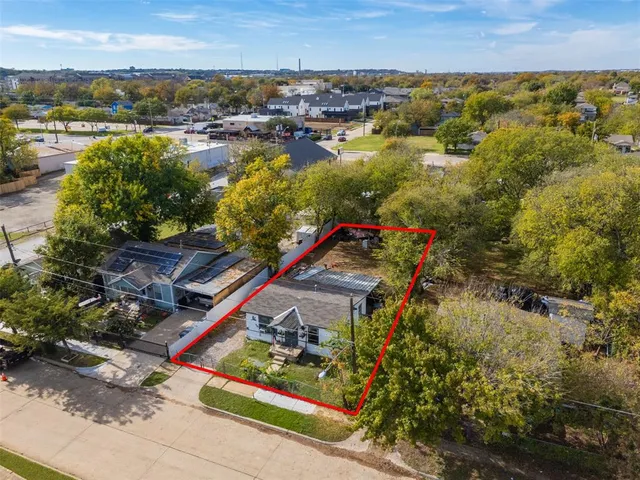 an aerial view of residential houses with outdoor space and river