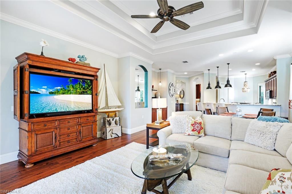 7599 Moorgate Point Way Naples, FL 34113 - Photo 13 of 38 a living room with furniture and a flat screen tv