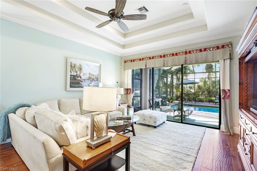 7599 Moorgate Point Way Naples, FL 34113 - Photo 14 of 38 a living room with furniture and a wooden floor