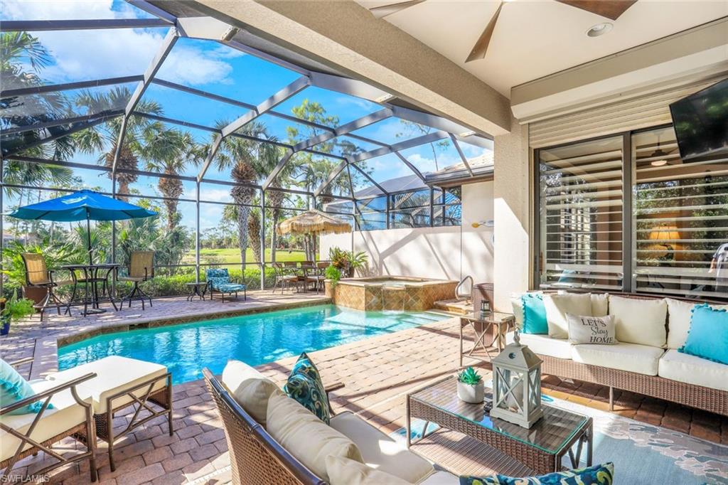 7599 Moorgate Point Way Naples, FL 34113 - Photo 15 of 38 a view of a swimming pool with a patio