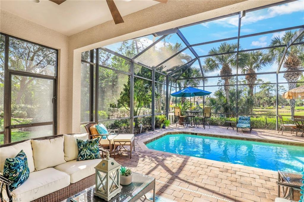 7599 Moorgate Point Way Naples, FL 34113 - Photo 16 of 38 a living room with furniture and a floor to ceiling window