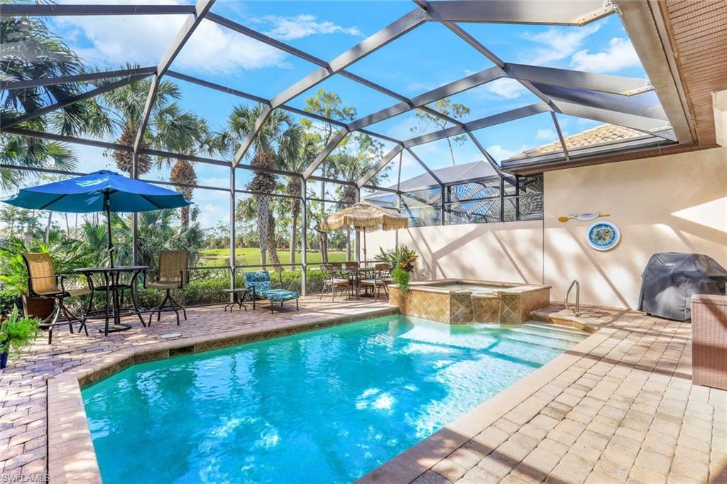 7599 Moorgate Point Way Naples, FL 34113 - Photo 17 of 38 a view of a swimming pool with a patio