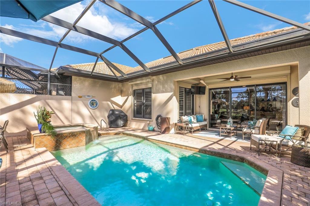 7599 Moorgate Point Way Naples, FL 34113 - Photo 18 of 38 a view of a backyard with a patio and swimming pool