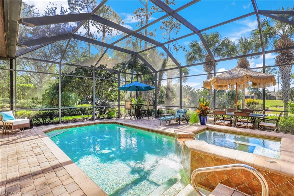 7599 Moorgate Point Way Naples, FL 34113 - Photo 19 of 38 a view of a swimming pool with a patio
