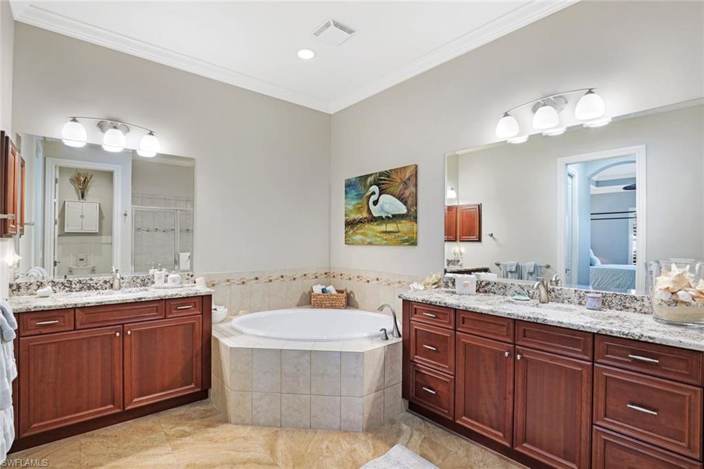 7599 Moorgate Point Way Naples, FL 34113 - Photo 23 of 38 a bathroom with a double vanity sink and a mirror