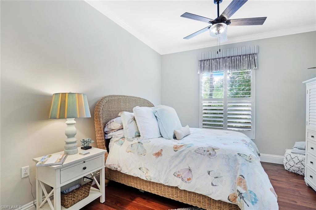 7599 Moorgate Point Way Naples, FL 34113 - Photo 25 of 38 a bedroom with a bed and window