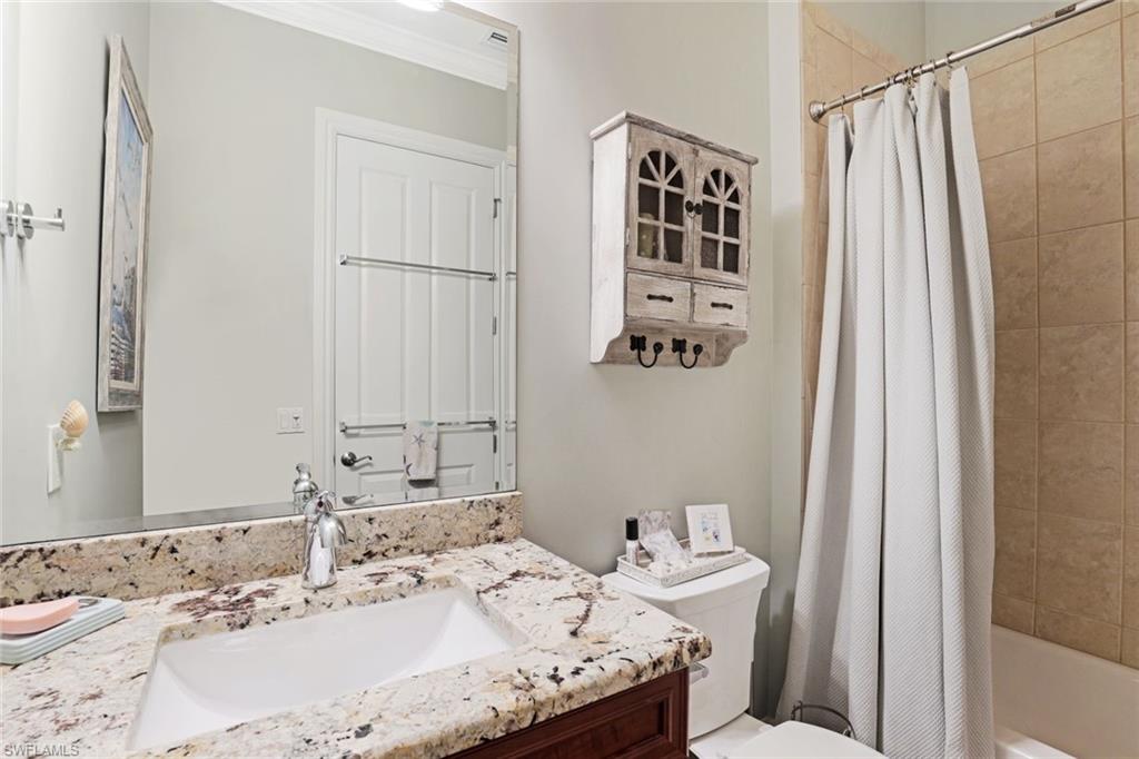 7599 Moorgate Point Way Naples, FL 34113 - Photo 26 of 38 a bathroom with a sink and a mirror