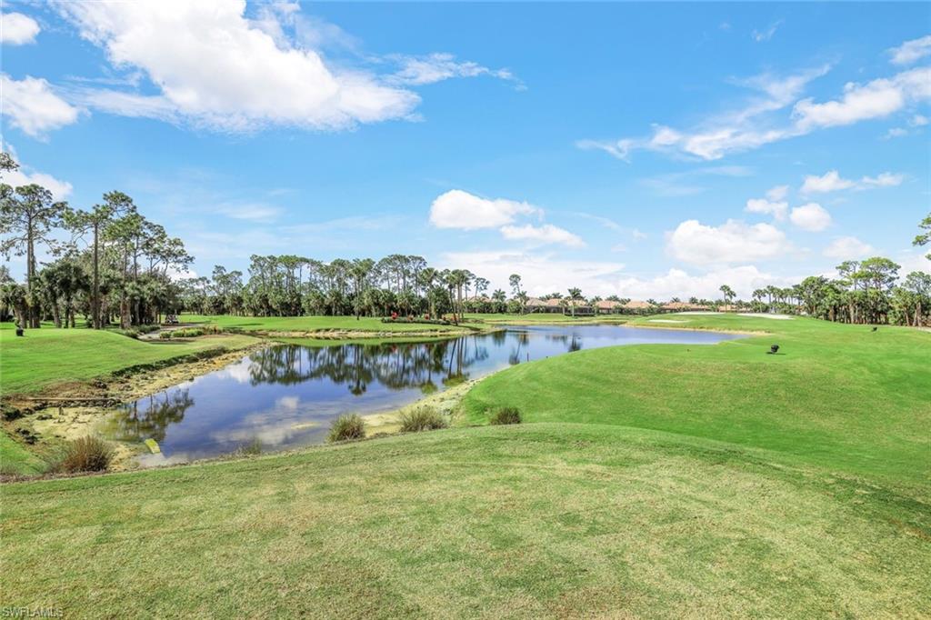 7599 Moorgate Point Way Naples, FL 34113 - Photo 32 of 38 a view of a lake with houses in the back