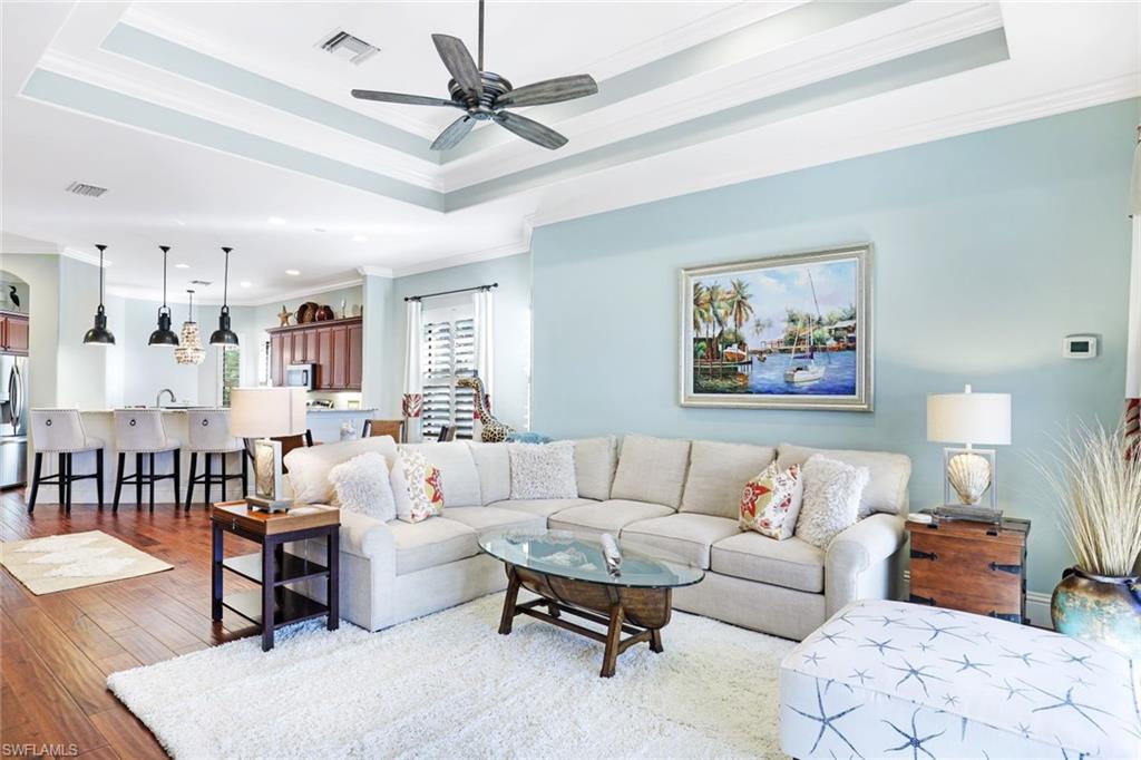 7599 Moorgate Point Way Naples, FL 34113 - Photo 9 of 38 a living room with furniture and a view of kitchen