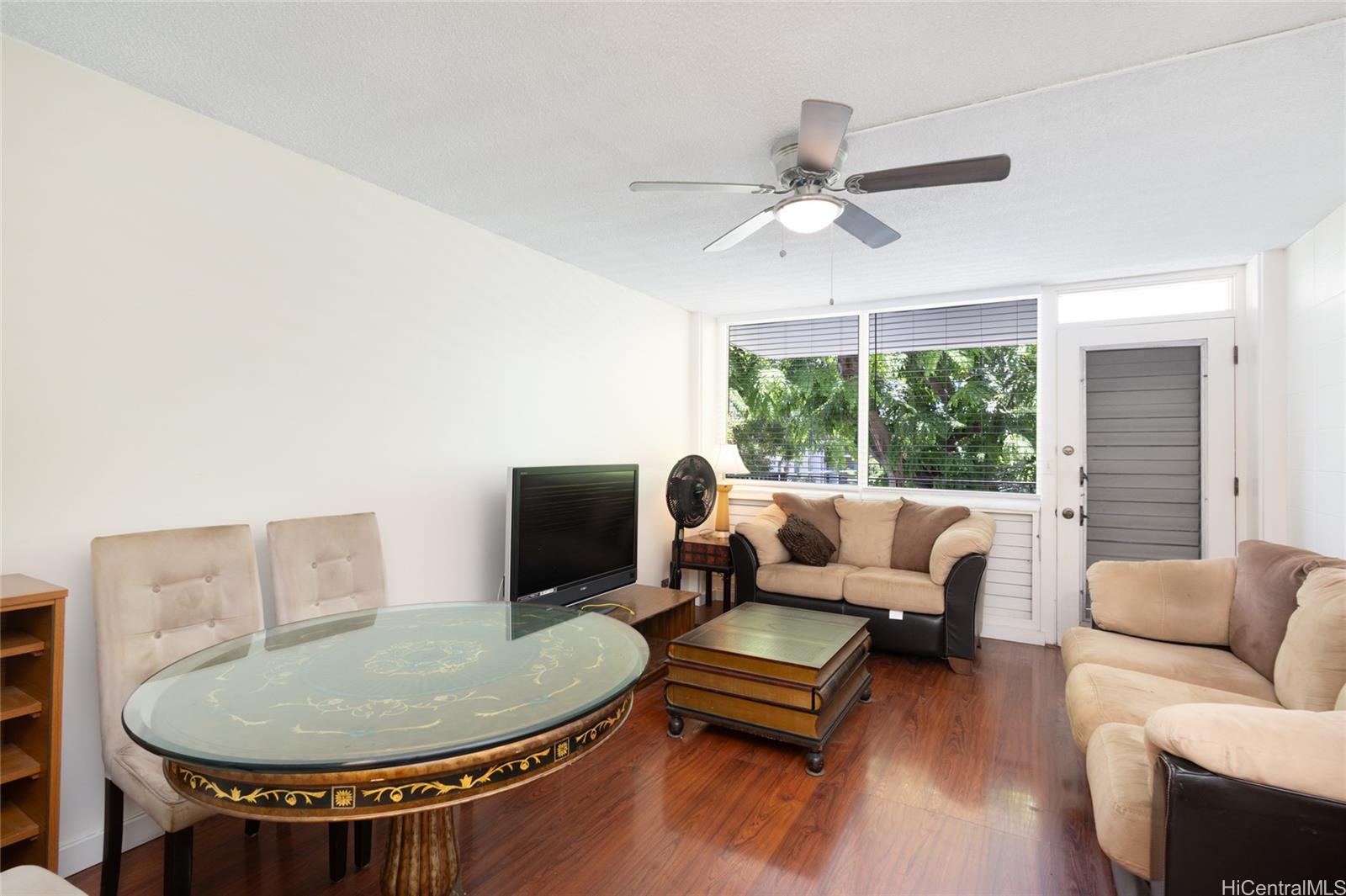 425 Ena Road, Unit 308C Honolulu, HI 96815 - Photo 2 of 10 a living room with furniture and a chandelier