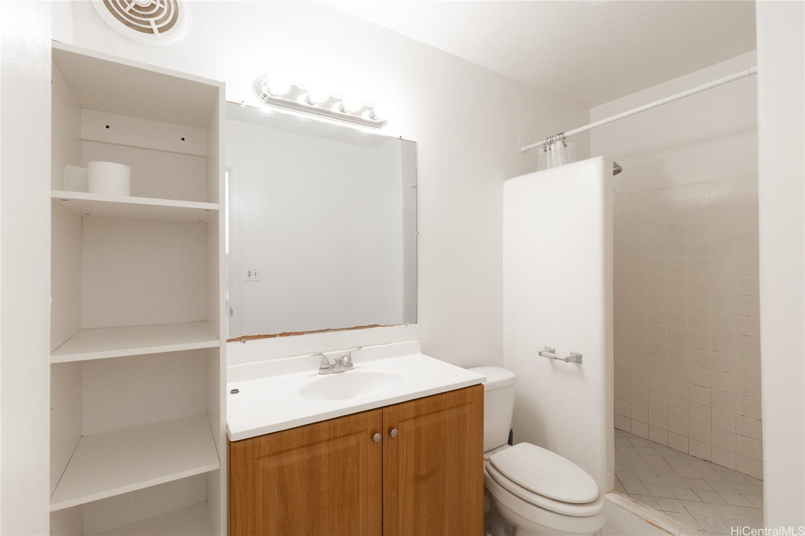 425 Ena Road, Unit 308C Honolulu, HI 96815 - Photo 4 of 10 a bathroom with a sink a toilet and shower
