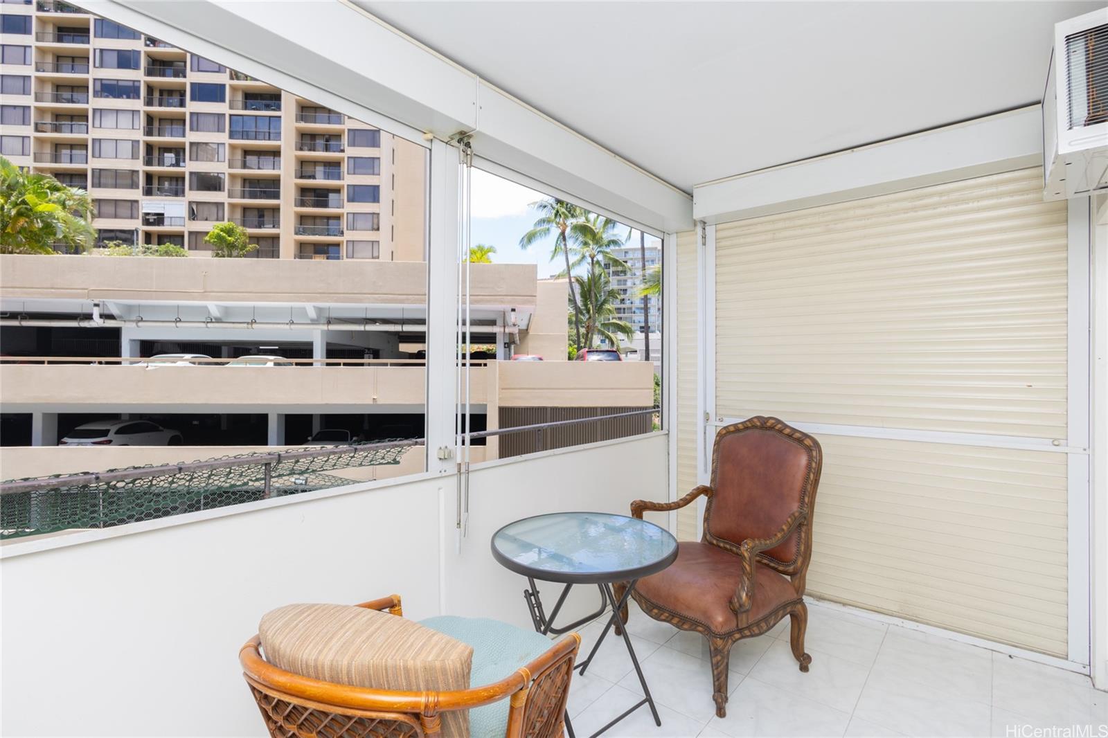 425 Ena Road, Unit 308C Honolulu, HI 96815 - Photo 7 of 10 a kitchen with a table chairs stove and a refrigerator
