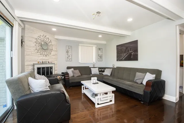 a living room with furniture window and a flat screen tv