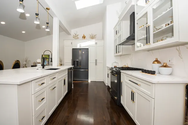 a kitchen with cabinets and stainless steel appliances