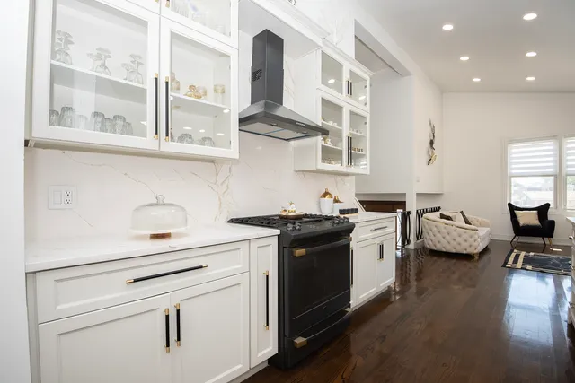 a kitchen with a stove and a white cabinets