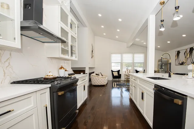 a kitchen with stainless steel appliances a stove sink and cabinets