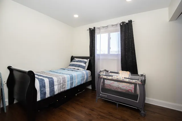 a bed room with a bed and a window