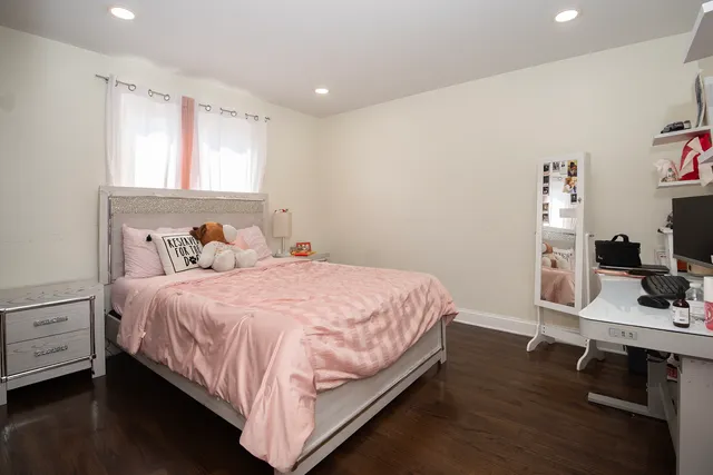 a bedroom with a bed and a desk