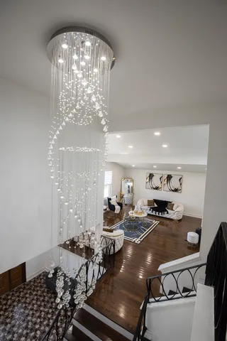 a room with lots of chairs and chandelier