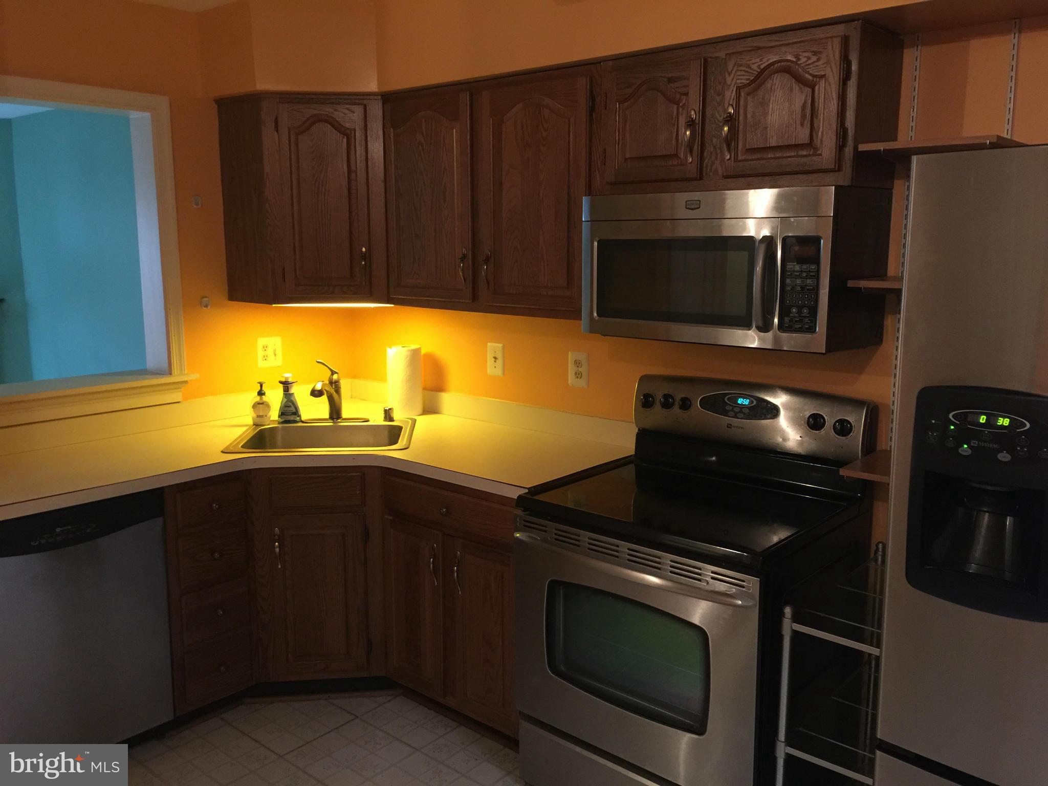 3969 Pepperidge Court Woodbridge, VA 22192 - Photo 2 of 11 a kitchen with stainless steel appliances wooden cabinets and a sink