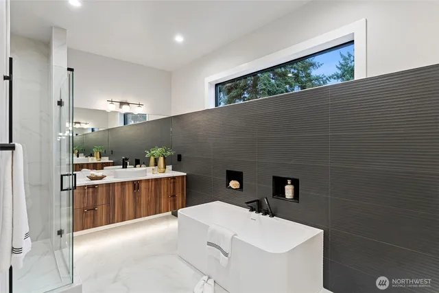 a bathroom with a sink a tub and a mirror