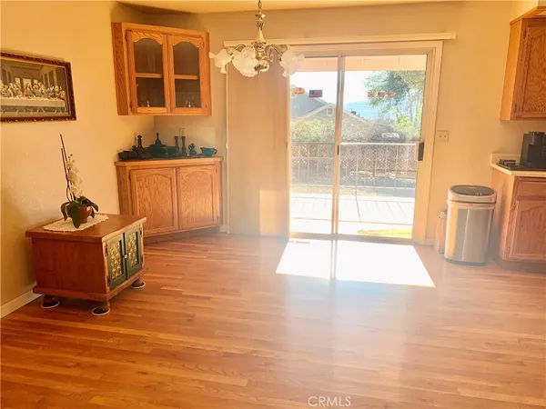 a living room with furniture a flat screen tv and a floor to ceiling window