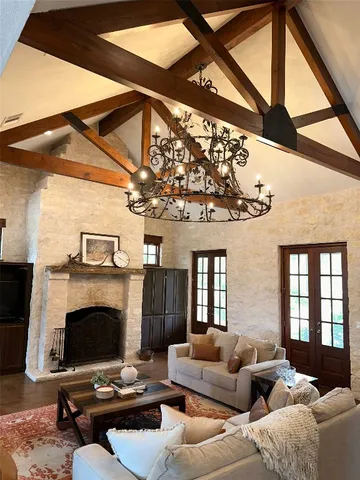 a living room with furniture a fireplace and a large window