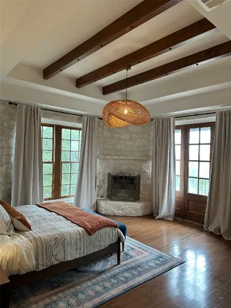 a spacious bedroom with a bed and a fireplace