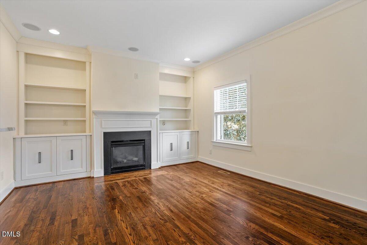 2718 Peachtree Street Raleigh, NC 27608 - Photo 11 of 38 a view of an empty room with a fireplace and a window