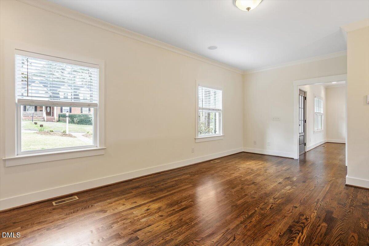 2718 Peachtree Street Raleigh, NC 27608 - Photo 13 of 38 a view of an empty room with wooden floor and a window