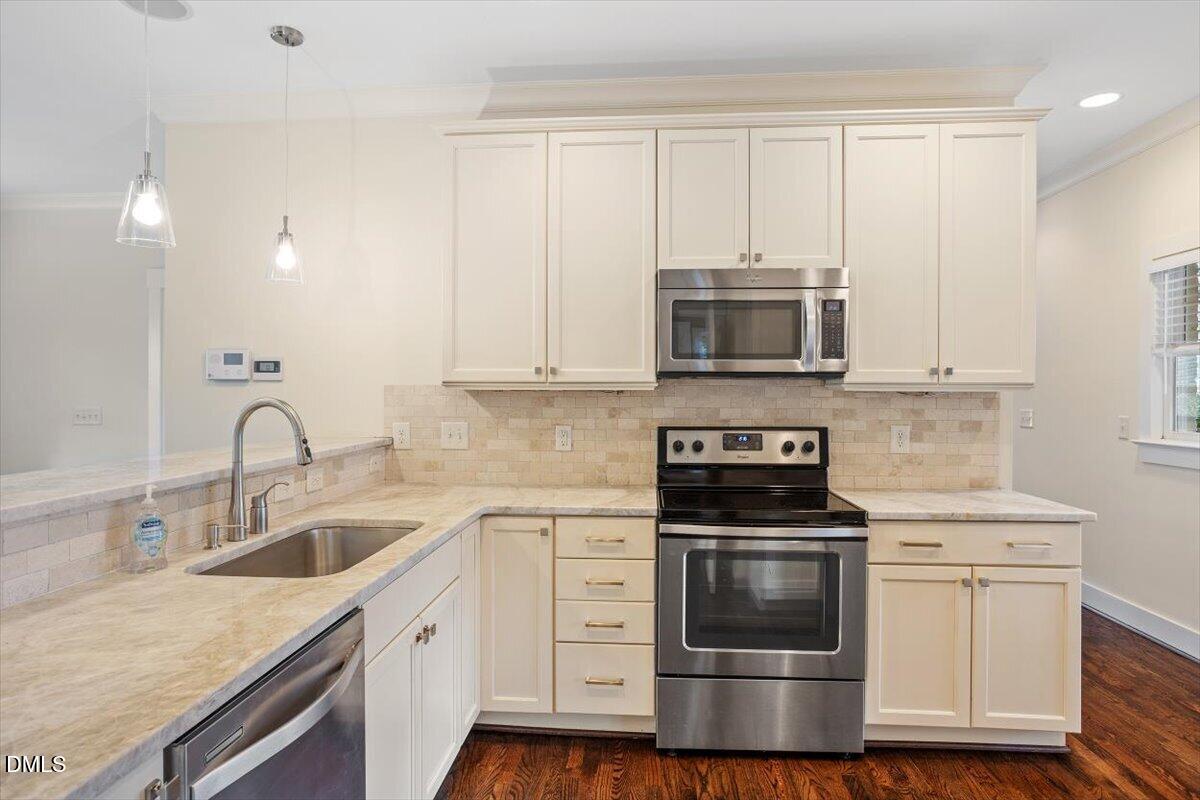 2718 Peachtree Street Raleigh, NC 27608 - Photo 14 of 38 a kitchen with granite countertop a stove and a sink