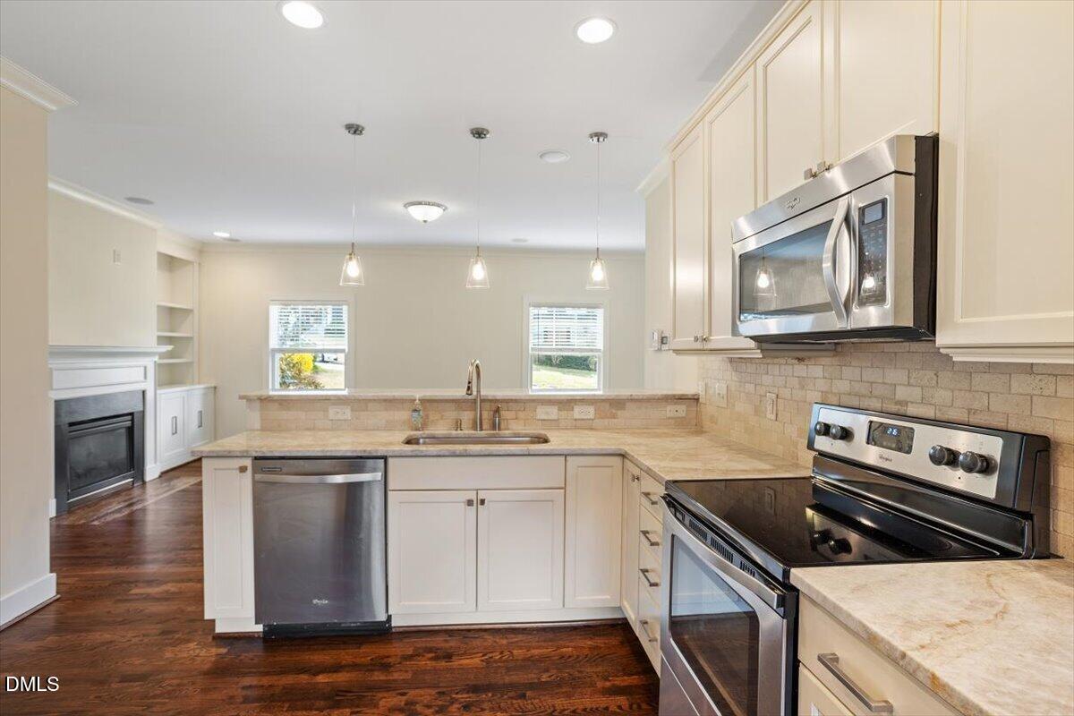 2718 Peachtree Street Raleigh, NC 27608 - Photo 15 of 38 a kitchen with stainless steel appliances granite countertop a stove a sink and a microwave