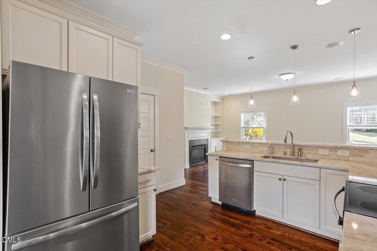 2718 Peachtree Street Raleigh, NC 27608 - Photo 17 of 38 a kitchen with a refrigerator sink and cabinets