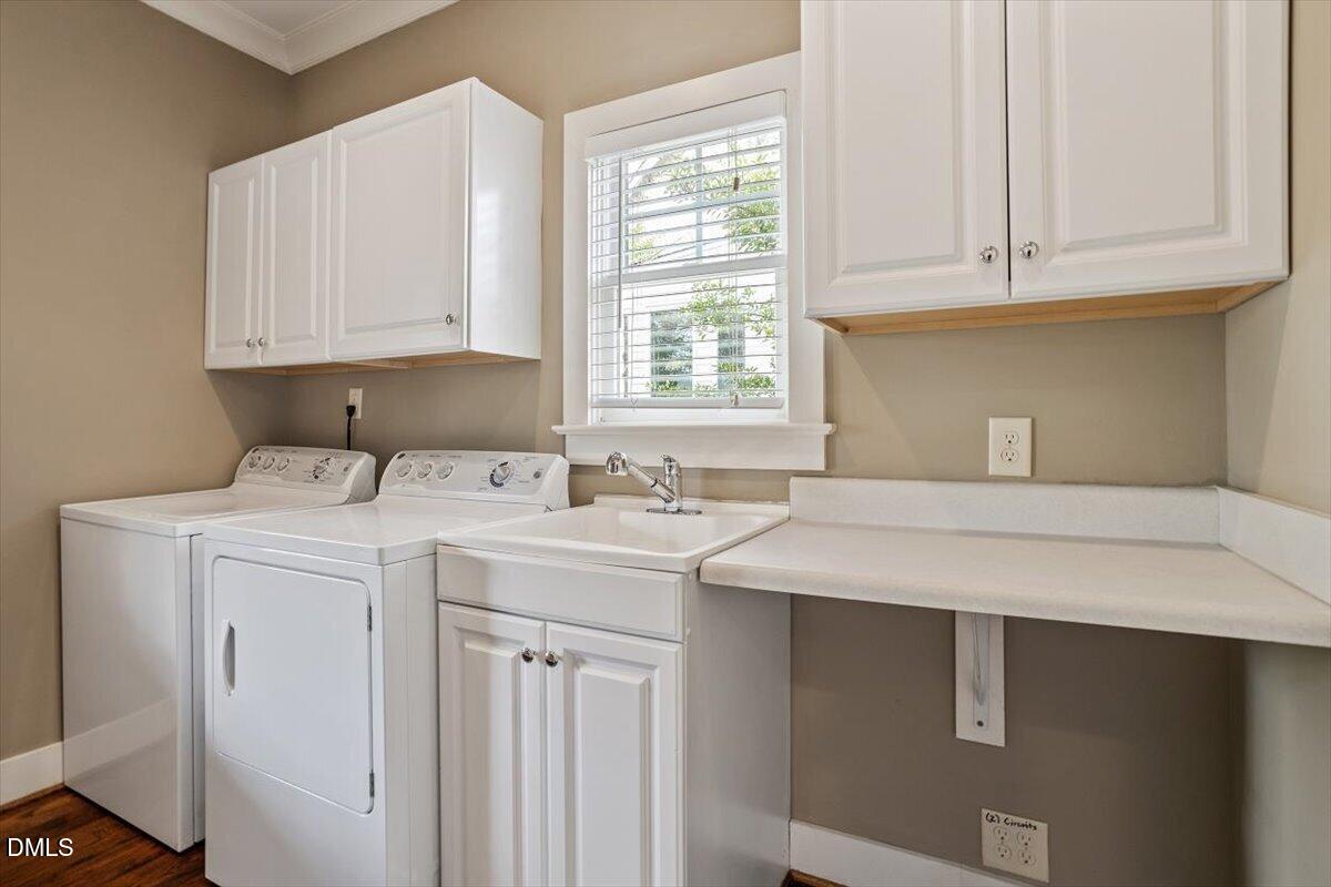 2718 Peachtree Street Raleigh, NC 27608 - Photo 18 of 38 a utility room with stainless steel appliances cabinets and a window
