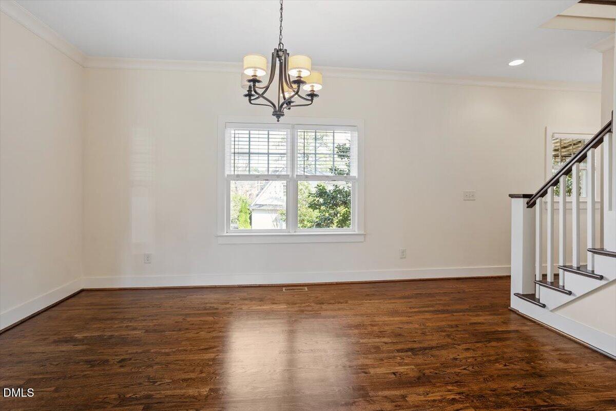 2718 Peachtree Street Raleigh, NC 27608 - Photo 19 of 38 a view of a room with wooden floor chandelier and windows
